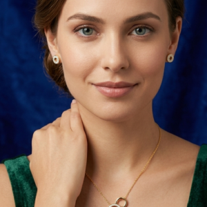 A woman with an elegant updo wearing the Lumina geometric gold and crystal pendant necklace and matching earrings, styled in a professional green velvet top against a blue background.